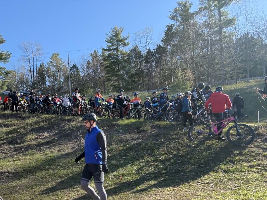 Mountain bikers lining up in the start chute for the annual Mud Sweat Beers MTB race at Mt. Holiday outside of Traverse City, MI — May 2026